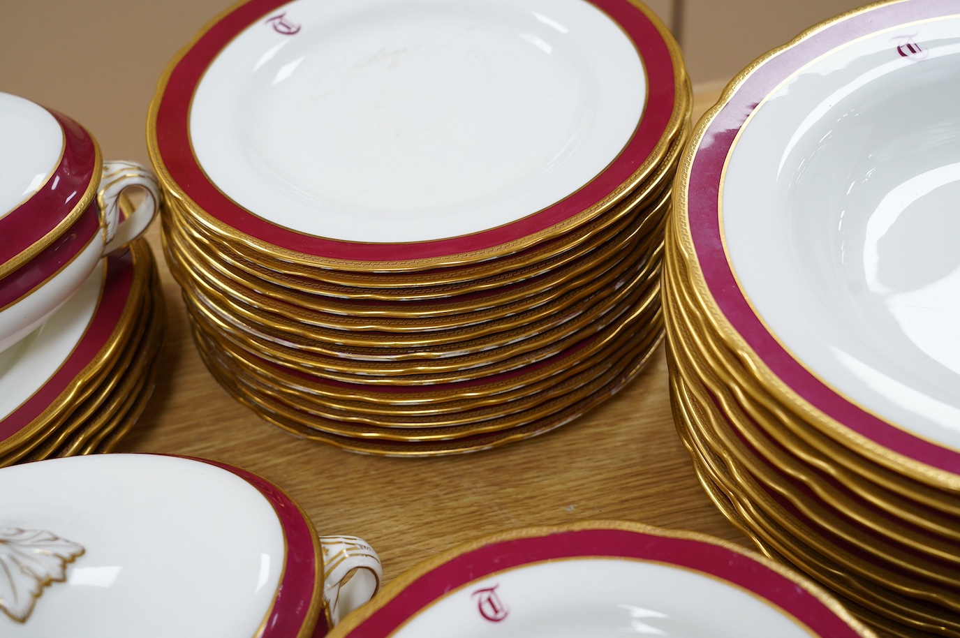 An extensive T. Goode & Co. Wedgwood red and gilt bordered dinner service, monogrammed 